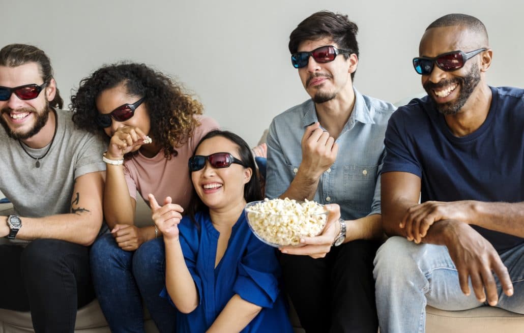 Group of diverse friends watching 3D movie together